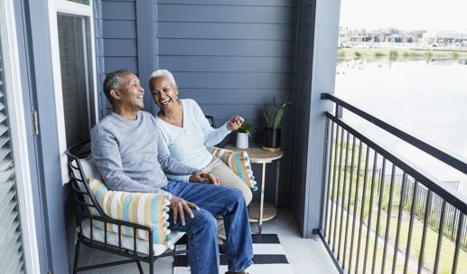 Woman and man sitting on balcony..